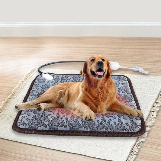 Dog lying on a patterned heating pad on a wooden floor.